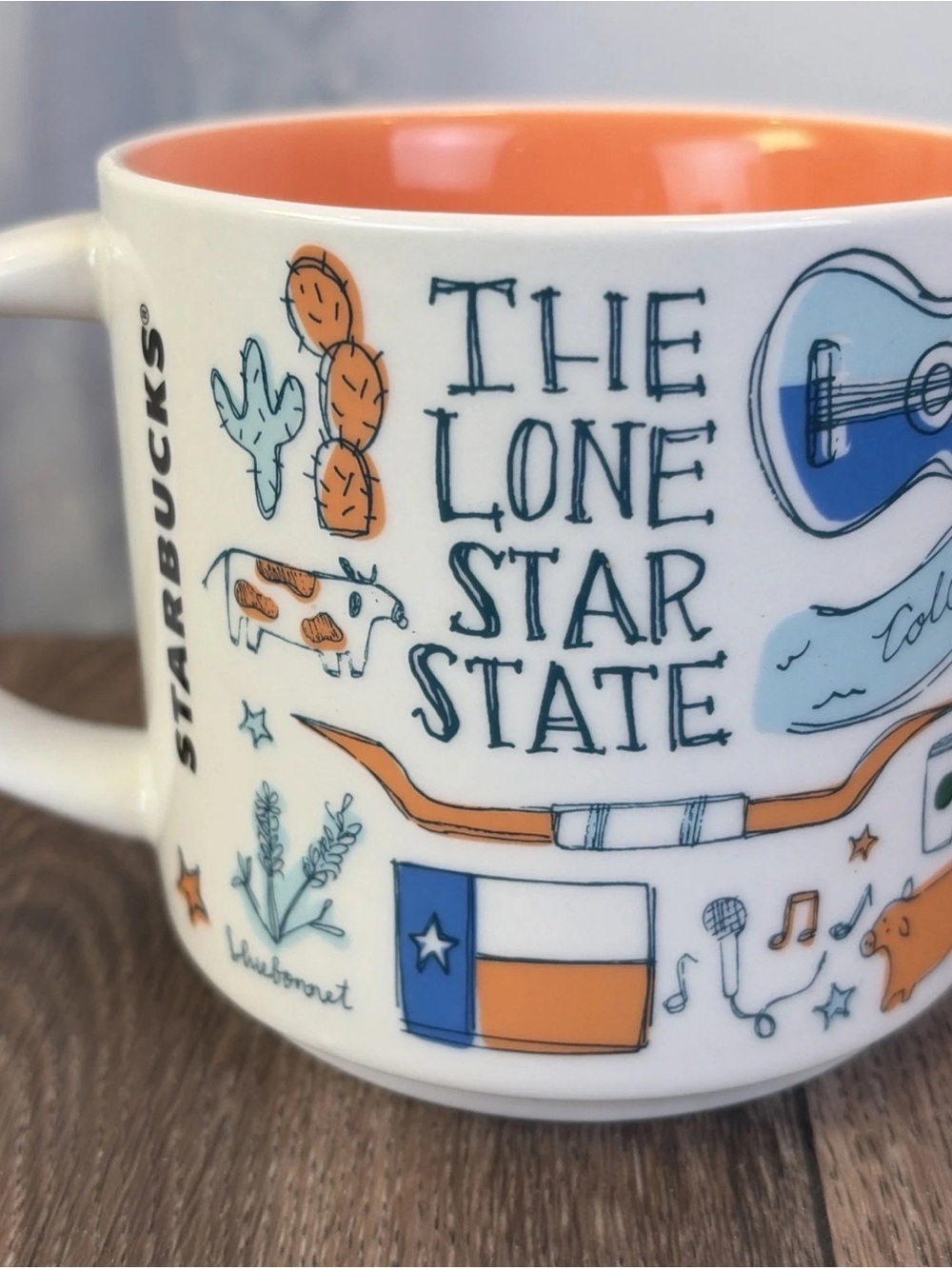 Starbucks White Ceramic Mug with Orange Interior and Blue Accents